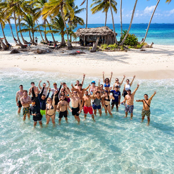 Un grupo grande de viajeros en el agua turquesa de una isla de San Blas