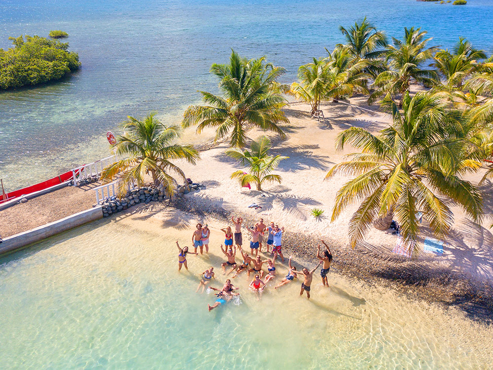 Calm turquoise water beside a palm island — no open ocean crossing